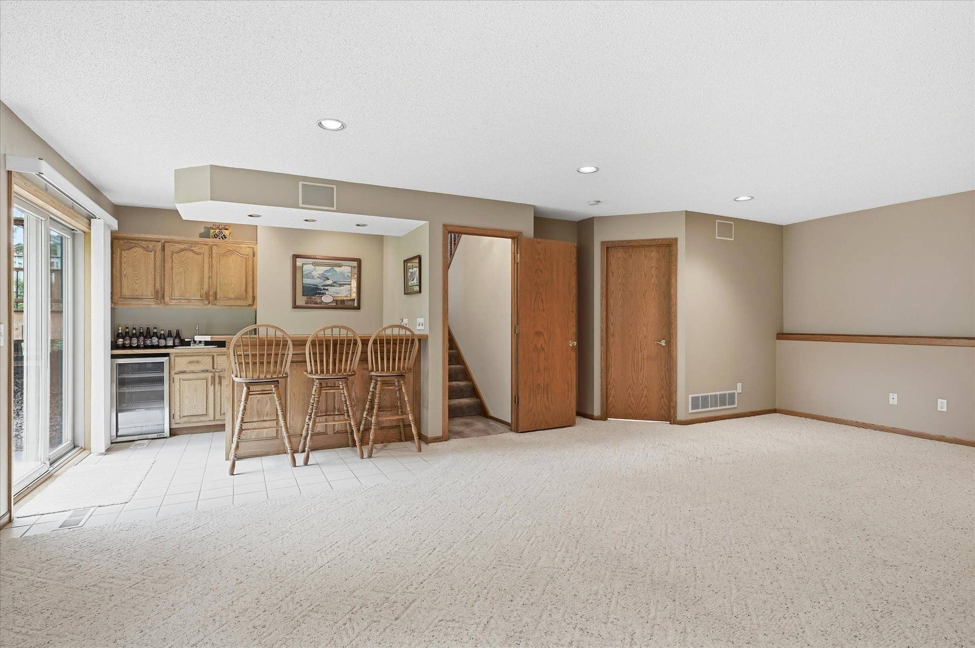 9225 Queens Gardens, Brooklyn Park, MN 55443 The generous layout offers plenty of flexibility for multiple seating areas, a game space, and entertaining.