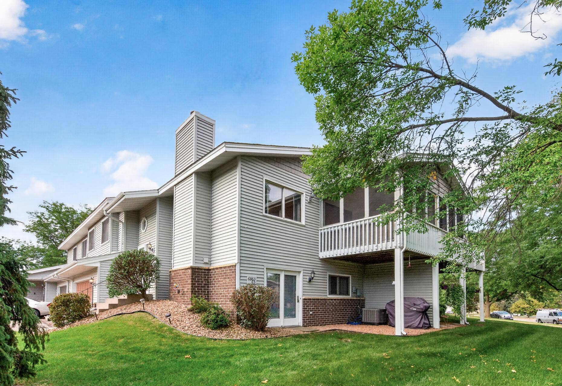 6865 Romeo Road, Woodbury, MN 55125 One of the perks of this end unit is the abundance of green space, perfect for setting up yard games or simply spending time outside.