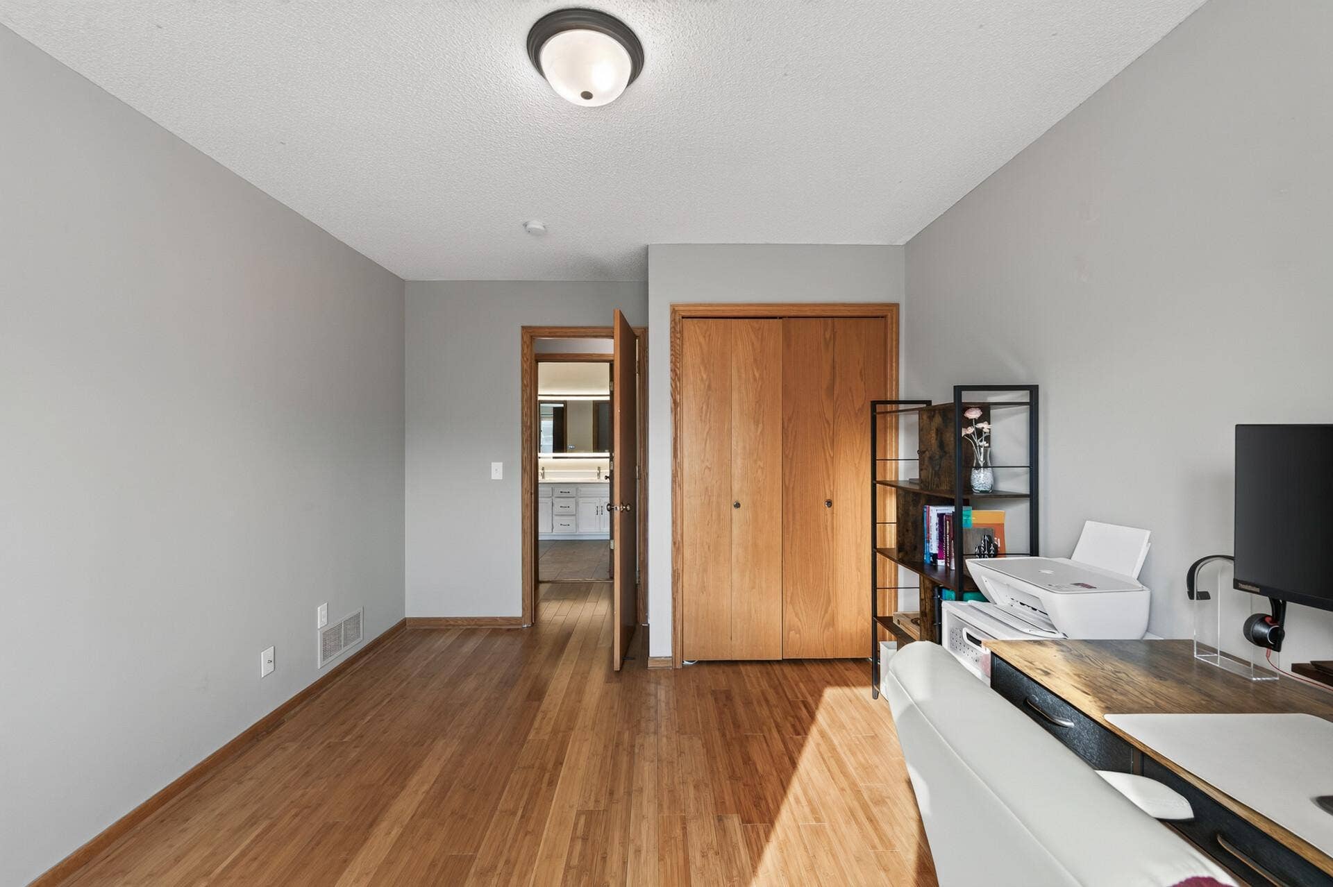 6865 Romeo Road, Woodbury, MN 55125 Bamboo flooring continues into the additional bedroom, creating a cohesive look throughout the upper level.