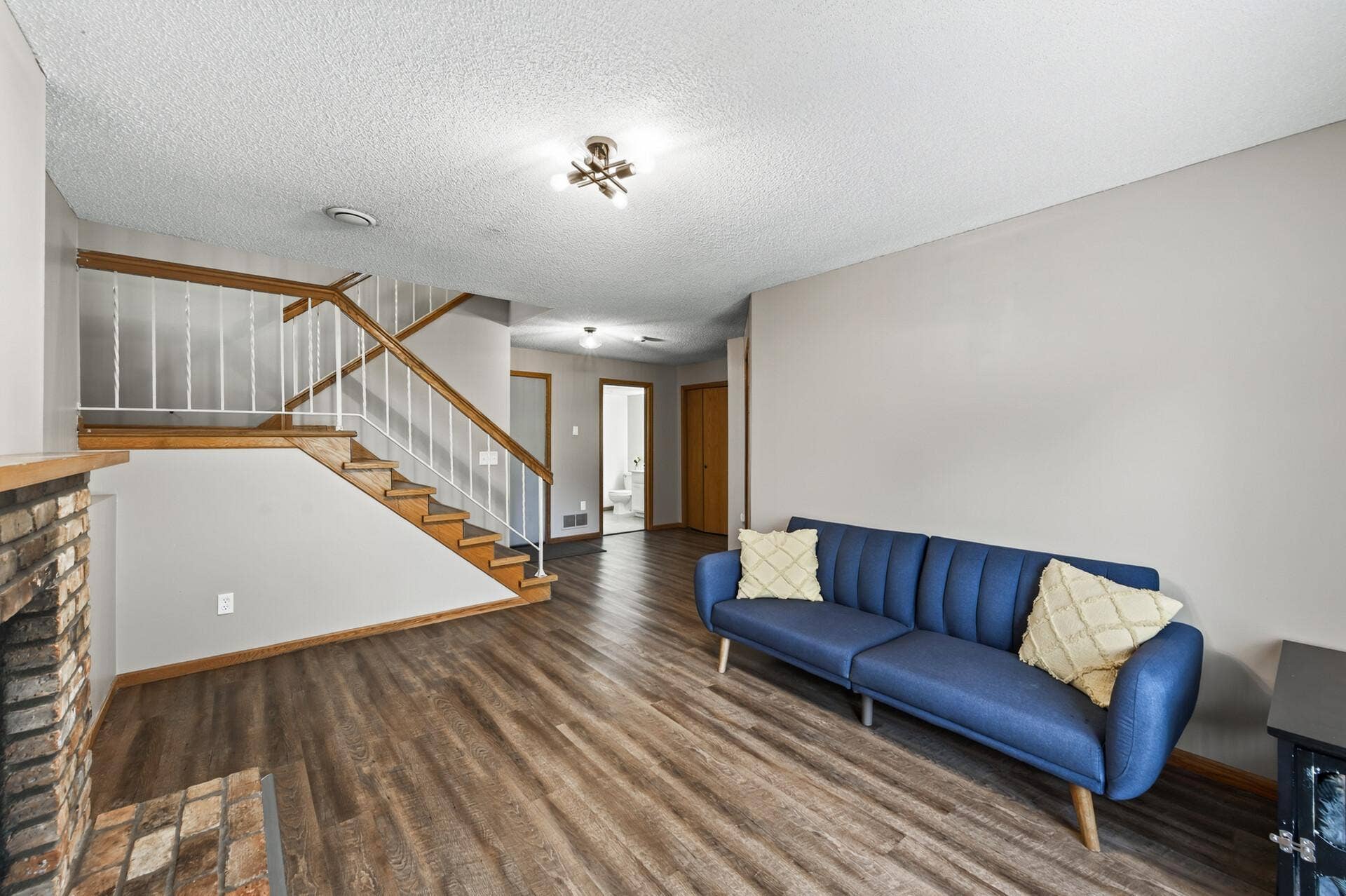 6865 Romeo Road, Woodbury, MN 55125 Fresh paint and LVP flooring give this roomy lower-level a refreshed feel, with convenient access to the outdoors.