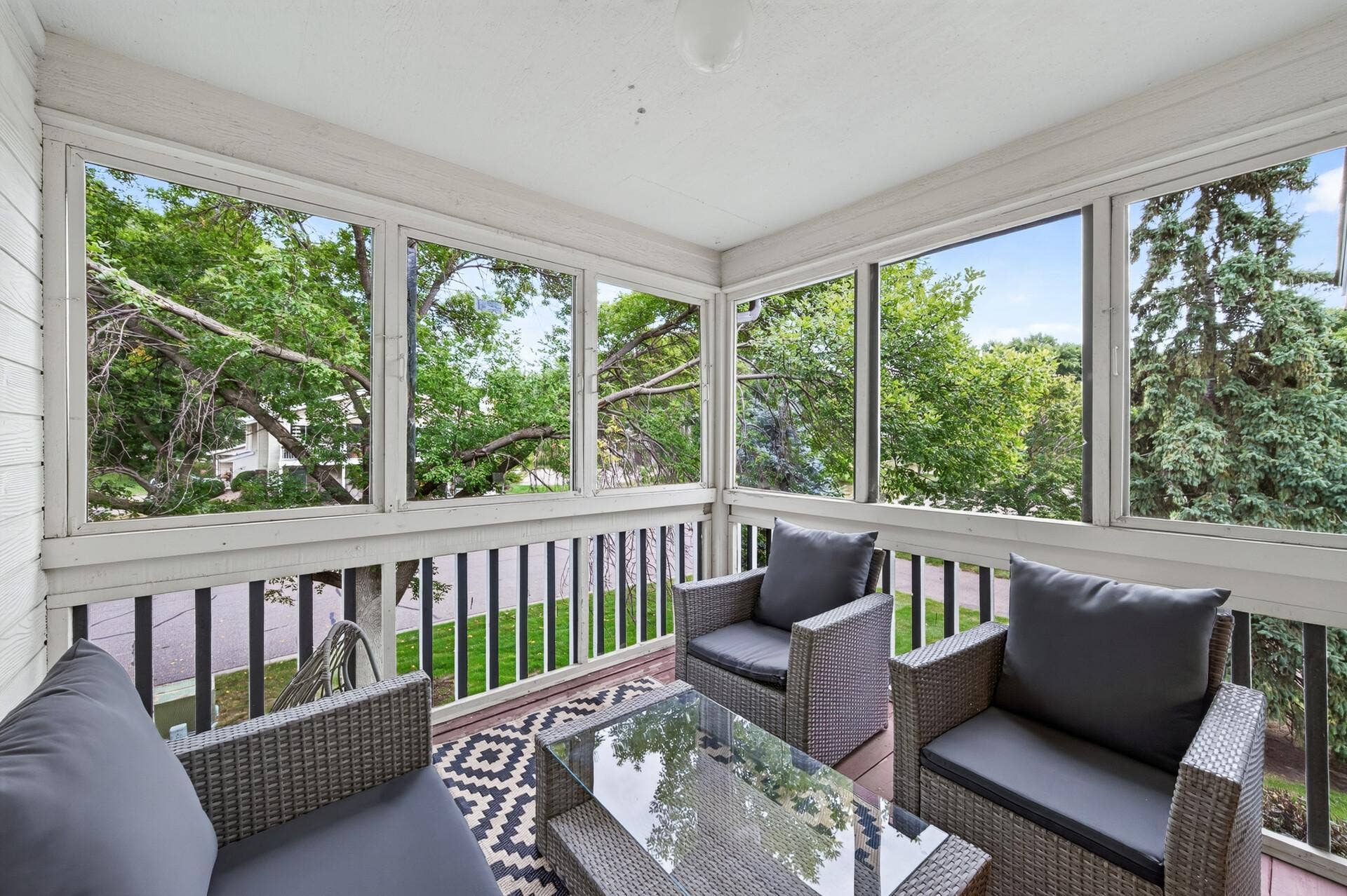 6865 Romeo Road, Woodbury, MN 55125 Transition onto the screened three-season porch, an ideal spot for morning coffee, reading or simply unwinding in the fresh air.
