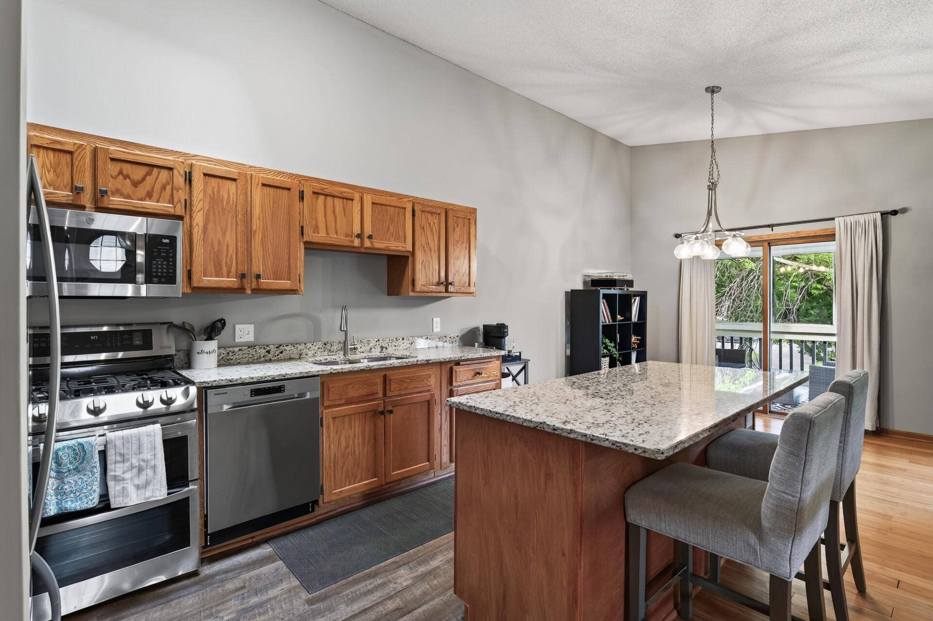 6865 Romeo Road, Woodbury, MN 55125 The kitchen features rich wood cabinetry, granite countertops, and stainless steel appliances.