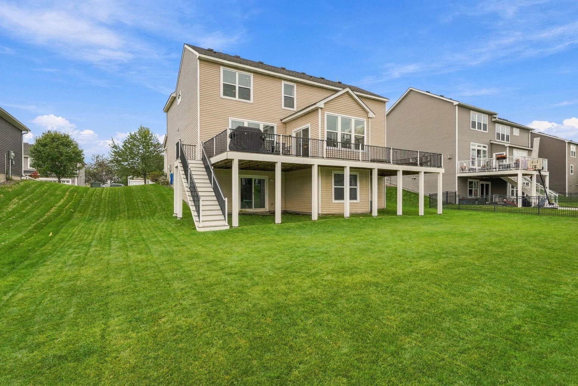 9324 Summerlin Road, Woodbury, MN 55129 Massive maintenance free decking that extends the entire length of the back of the home.