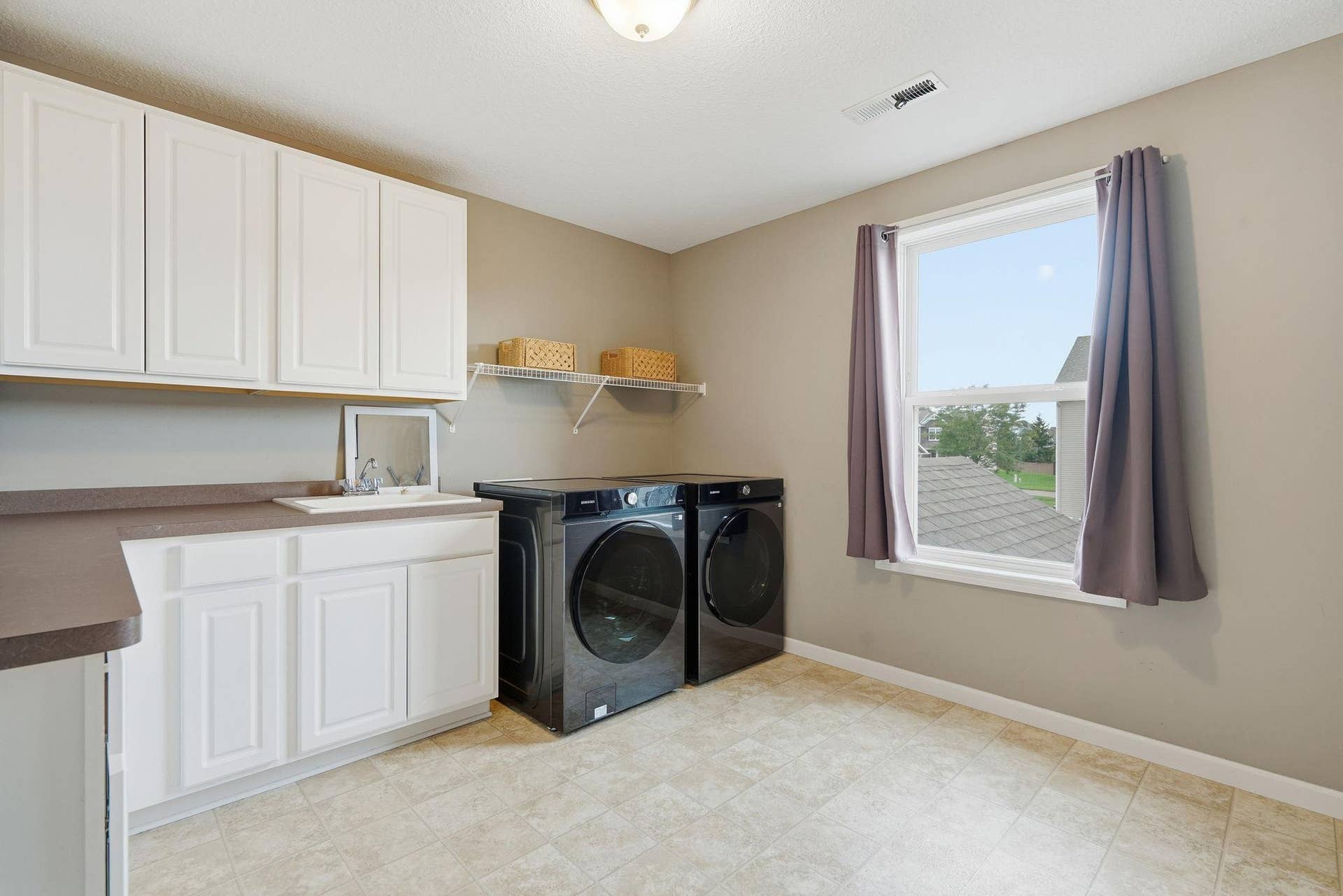 9324 Summerlin Road, Woodbury, MN 55129 Oversized upper level laundry room with sink and custom cabinetry!