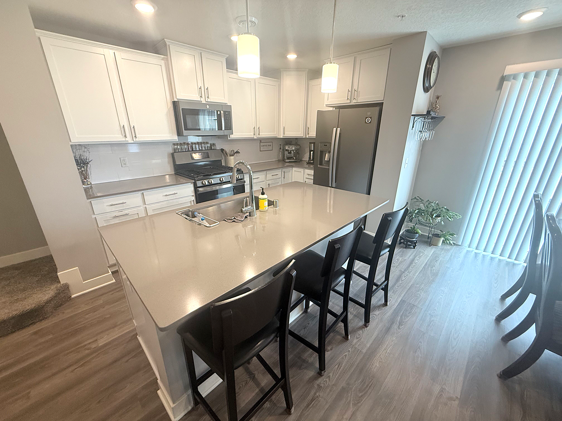 7238 Dora Drive, Hugo, MN 55038 Beautifully designed kitchen featuring a large center island with seating and stainless steel appliances.