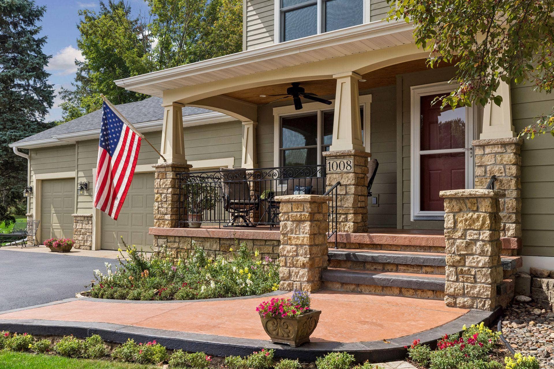 1008 Eagle Ridge Court, Stillwater, MN 55082 This front porch is made for morning coffee, welcoming guests, or catching up with neighbors during a cul-de-sac gathering. Stone columns, a beautifully crafted wood ceiling, and a ceiling fan make it extra special.