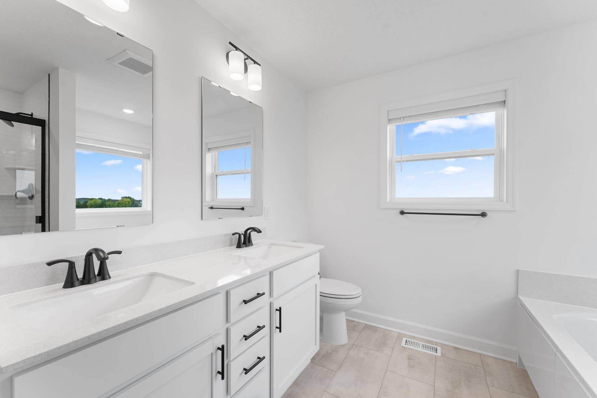 A glass-enclosed shower and nearby soaking tub provide daily escapes in the owners bathroom