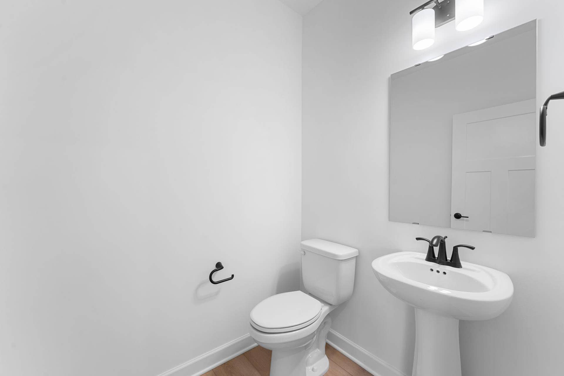 Guests and residents have easy access to a private powder room near first-floor living spaces.