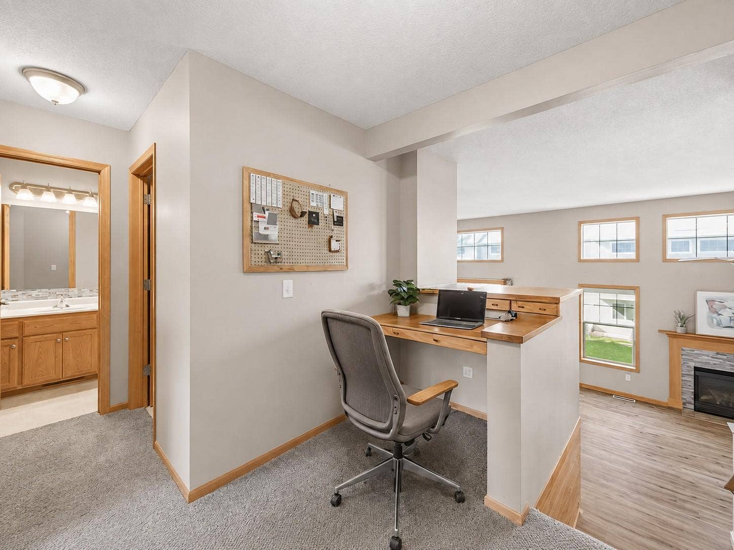 11631 Prospect Curve, Woodbury, MN 55129 The built-in upper-level home office overlooks the dramatic two-story living room, creating an open, spacious workspace filled with natural light.
