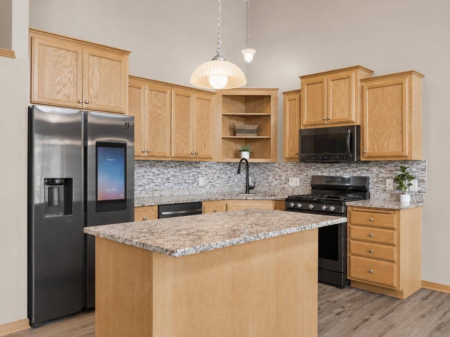 11631 Prospect Curve, Woodbury, MN 55129 The heart of the home, this open-concept kitchen offers granite countertops, stainless steel appliances, a smart refrigerator, and a spacious island that's perfect for gathering, entertaining, or casual meals.
