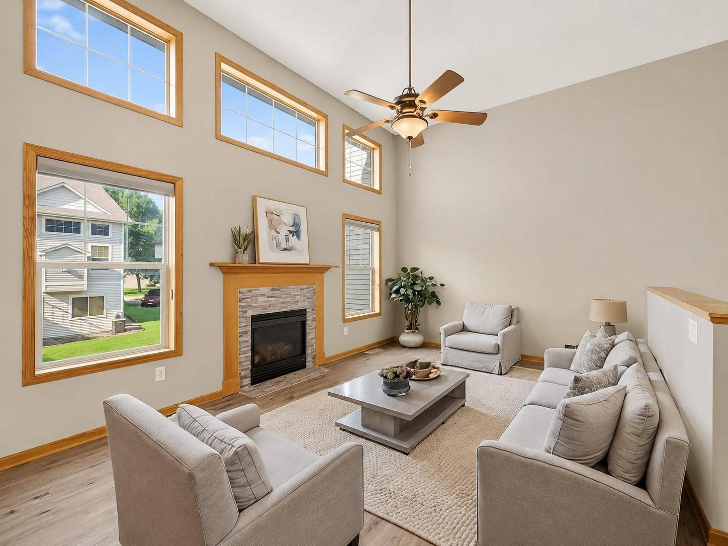 11631 Prospect Curve, Woodbury, MN 55129 The dramatic two-story living room is filled with natural light from soaring windows and features a cozy gas fireplace with a classic mantel, plus plenty of space for large-scale furniture.