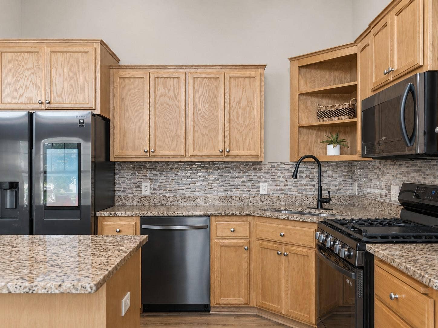 11631 Prospect Curve, Woodbury, MN 55129 You'll love the premium stainless steel appliance package, featuring a gas range, smart refrigerator, dishwasher, and built-in microwave. I love the faucet, it ties in the updated kitchen.