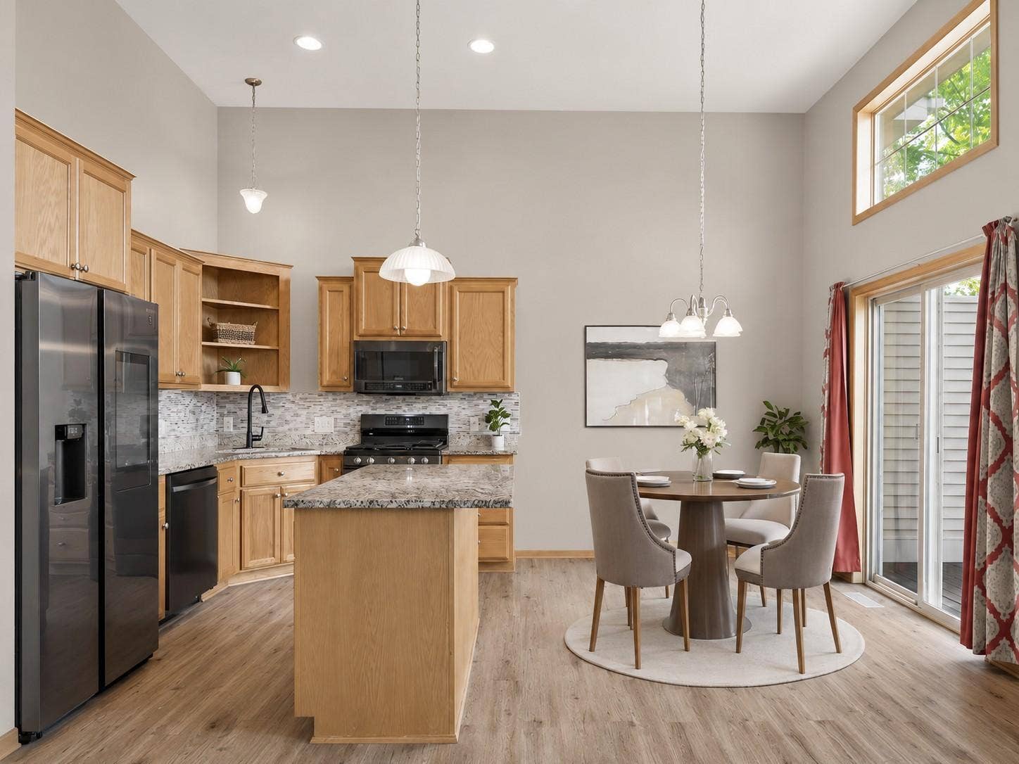 11631 Prospect Curve, Woodbury, MN 55129 An open-concept layout seamlessly connects the kitchen, dining area, and deck that is perfect for everyday living and effortless entertaining!