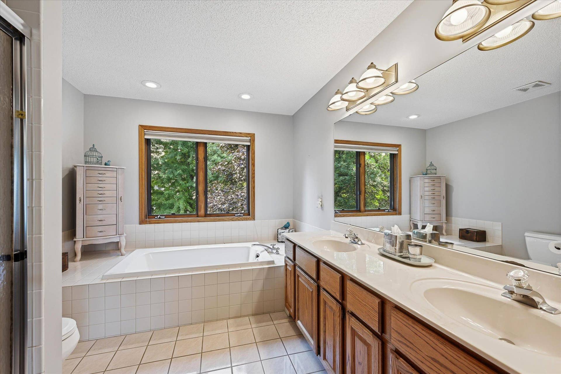11412 Louisiana Avenue S, Bloomington, MN 55438 The private primary bath features a separate tub and shower, creating a functional and comfortable retreat.