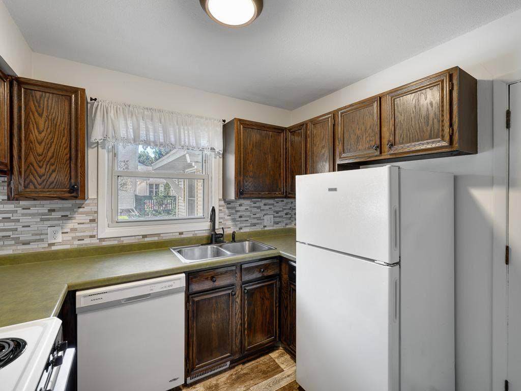4954 Grenwich Trail N, Oakdale, MN 55128 This functional kitchen has a window that overlooks the patio area.