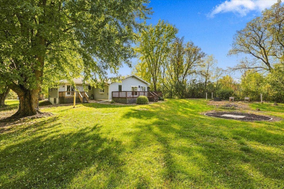 272 Glenmont Road, River Falls, WI 54022 Large private backyard with big, mature trees, open green space and a fire pit area for bonfires.
