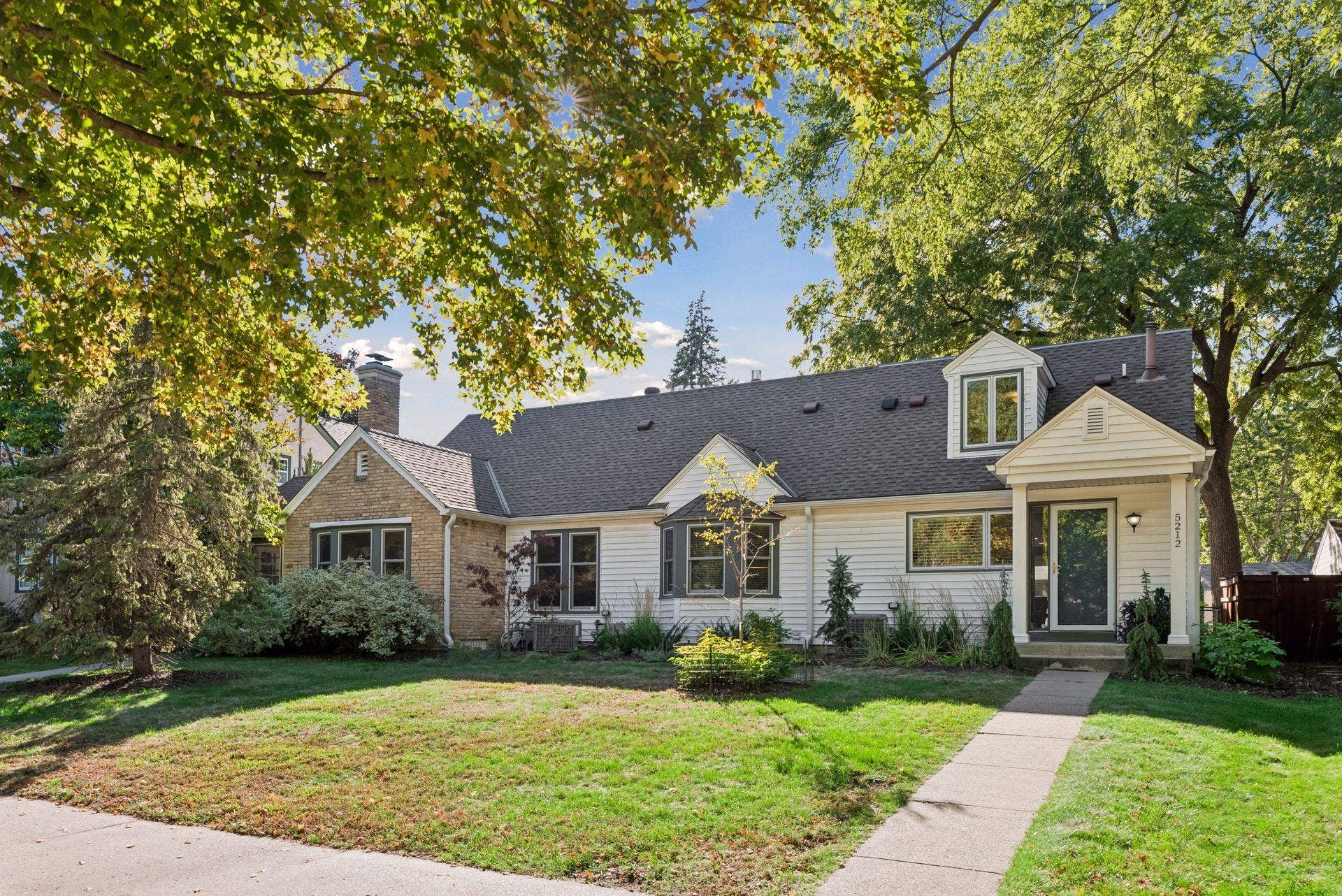 5212 Humboldt Avenue S, 49, Minneapolis, MN 55419 Front Exterior - Front view highlights the homes broad footprint, mature trees, landscaped yard, dormer window, bay window, and welcoming covered entry.