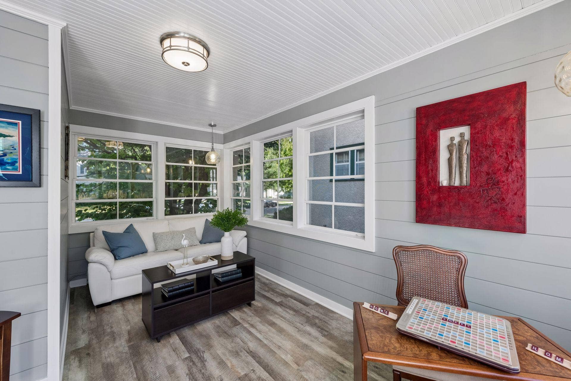 5212 Humboldt Avenue S, 49, Minneapolis, MN 55419 Sunroom - Bright sunroom features windows on multiple sides, horizontal wall paneling, beadboard ceiling, updated flooring, and flexible space for an office, sitting room, or creative space.