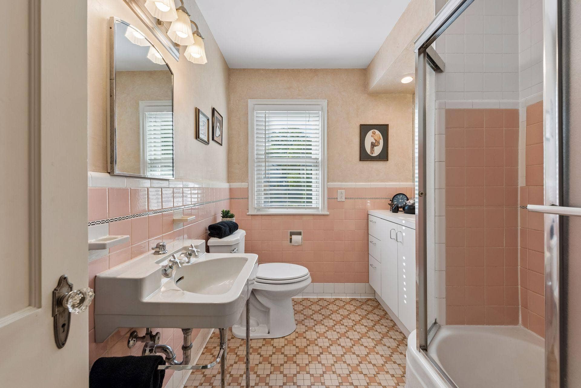 5212 Humboldt Avenue S, 49, Minneapolis, MN 55419 Full Main Floor Bathroom - Vintage character shines in this full bath with classic pink tile, mosaic tile flooring, pedestal sink, additional cabinetry, and a tub/shower.