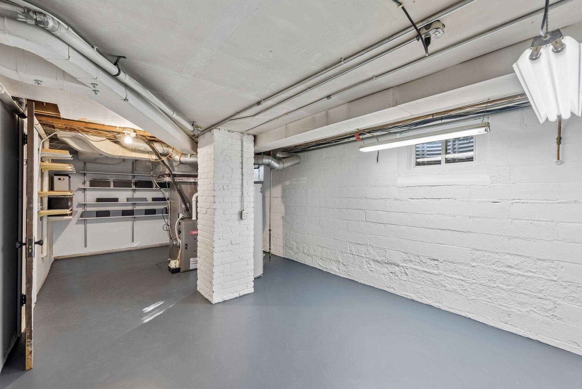 5212 Humboldt Avenue S, 49, Minneapolis, MN 55419 Utility & Storage Room - Clean, functional lower-level utility space offers room for storage and workshop use, with painted walls and floor, shelving, and convenient access to mechanical systems.