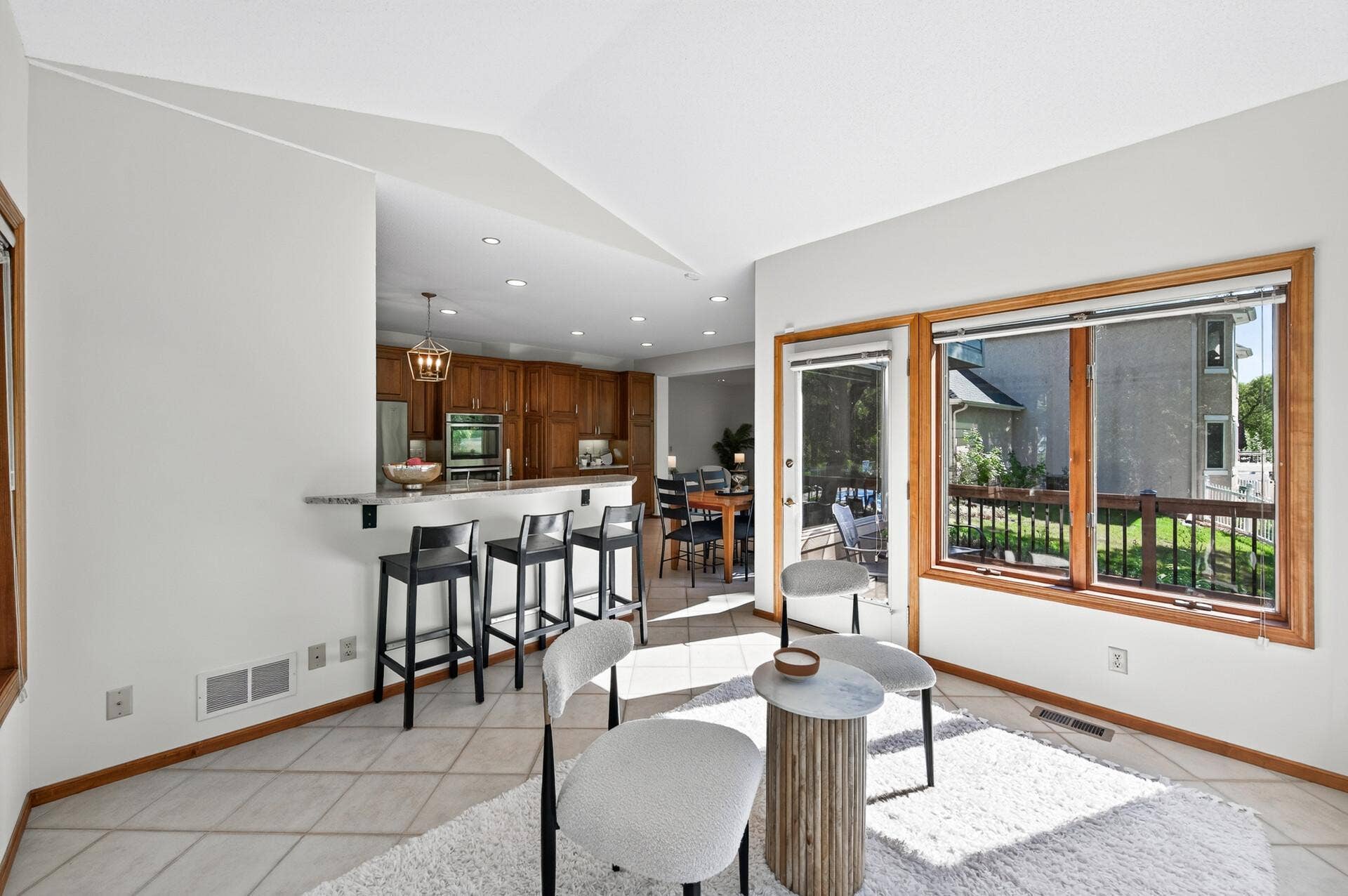 3034 Edgewater Drive, Woodbury, MN 55125 sunroom looking back into kitchen and living room