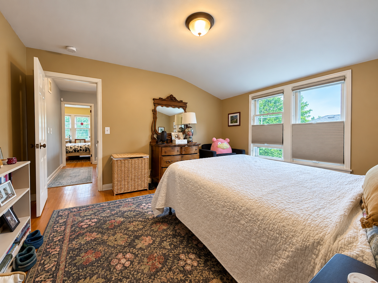 5921 Chicago Avenue S, 17, Minneapolis, MN 55417 Space for bedside tables, your favorite dresser and books within reach. This reverse view shows a bedroom that accommodates everyday living, with paired windows and wood floors continuing into the hall.