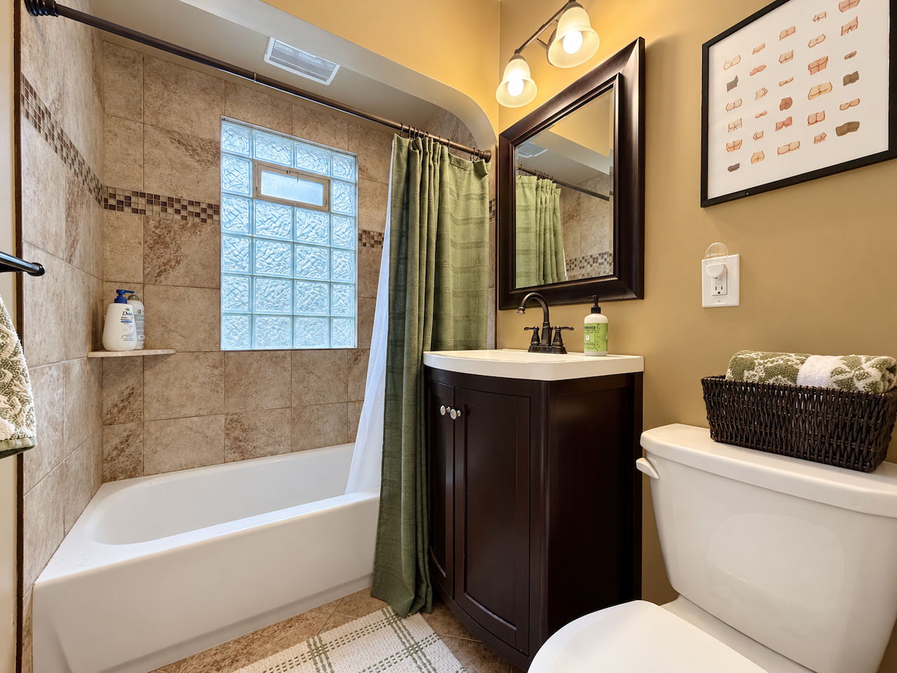 5921 Chicago Avenue S, 17, Minneapolis, MN 55417 A soak after a long day or a quick start to the morning. The tiled tub surround, vanity storage and glass-block window pair everyday function with natural light and privacy.