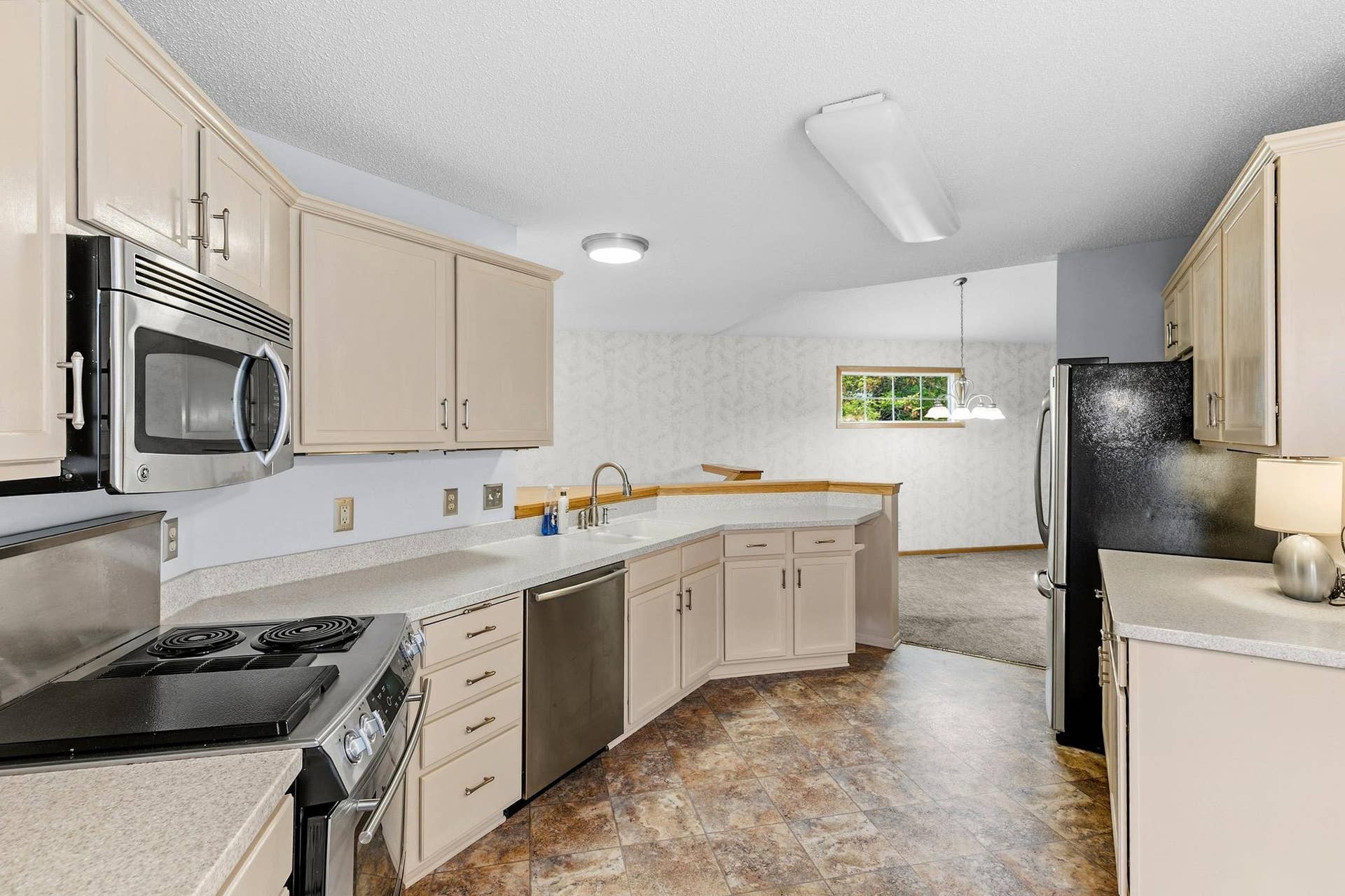3848 Linden Avenue, White Bear Lake, MN 55110 The kitchen with solid surface countertops, stainless appliances and a pantry.