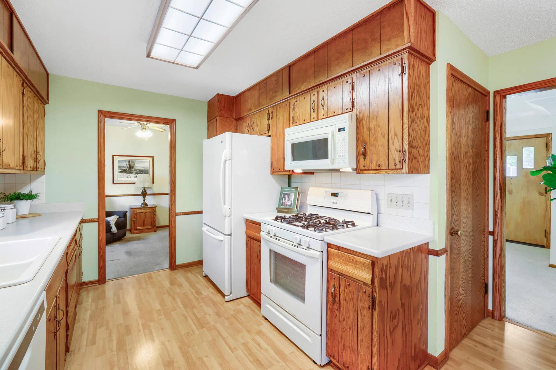 8901 Fremont Avenue S, Bloomington, MN 55420 This kitchen has a warm, classic feel with rich wood cabinetry, plenty of storage, and generous counter space for everyday cooking and prep. White appliances, gas range and plenty of space makes it great for entertaining