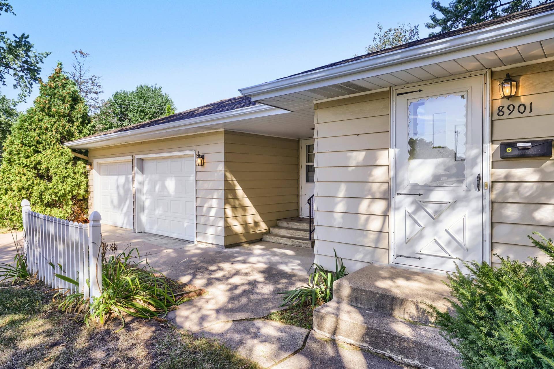 8901 Fremont Avenue S, Bloomington, MN 55420 A covered side/back entry provides a convenient, sheltered access point into the home, with steps leading to the door and direct proximity to the 2-car attached garage. The overhang helps protect the entrance from the elements
