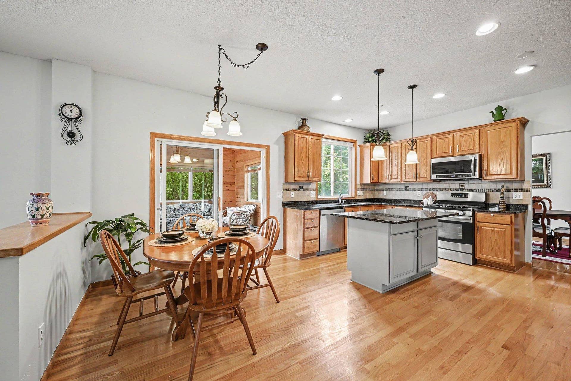 2466 Lone Eagle Trail, Woodbury, MN 55129 Recently installed hardwood floors, informal dining, sliding glass door to the 4 season porch, granite countertops, recessed lighting , kitchen opens up to the family room.