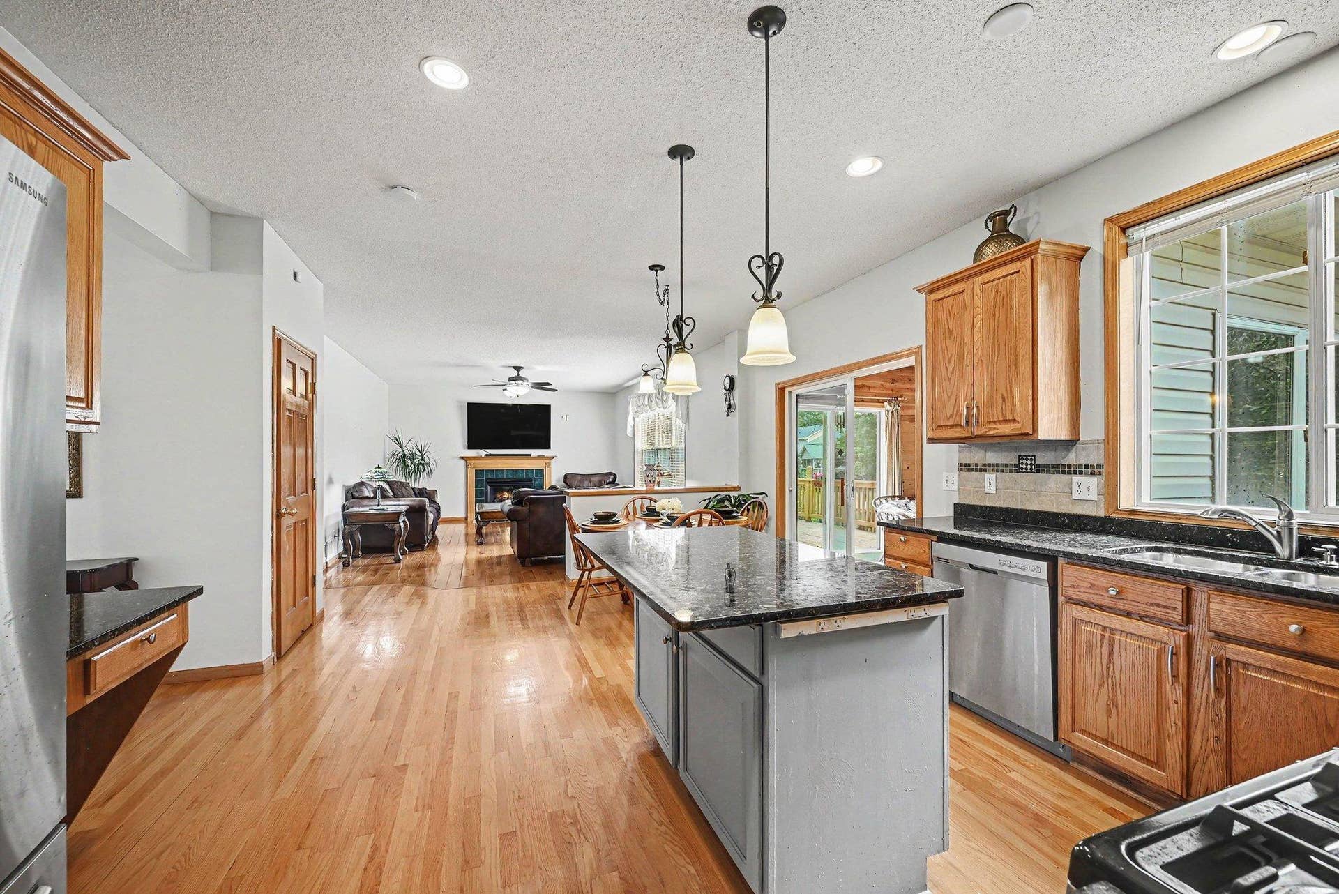 2466 Lone Eagle Trail, Woodbury, MN 55129 Open view from the kitchen to the family room and the deck. New hardwood floors throughout the main level.