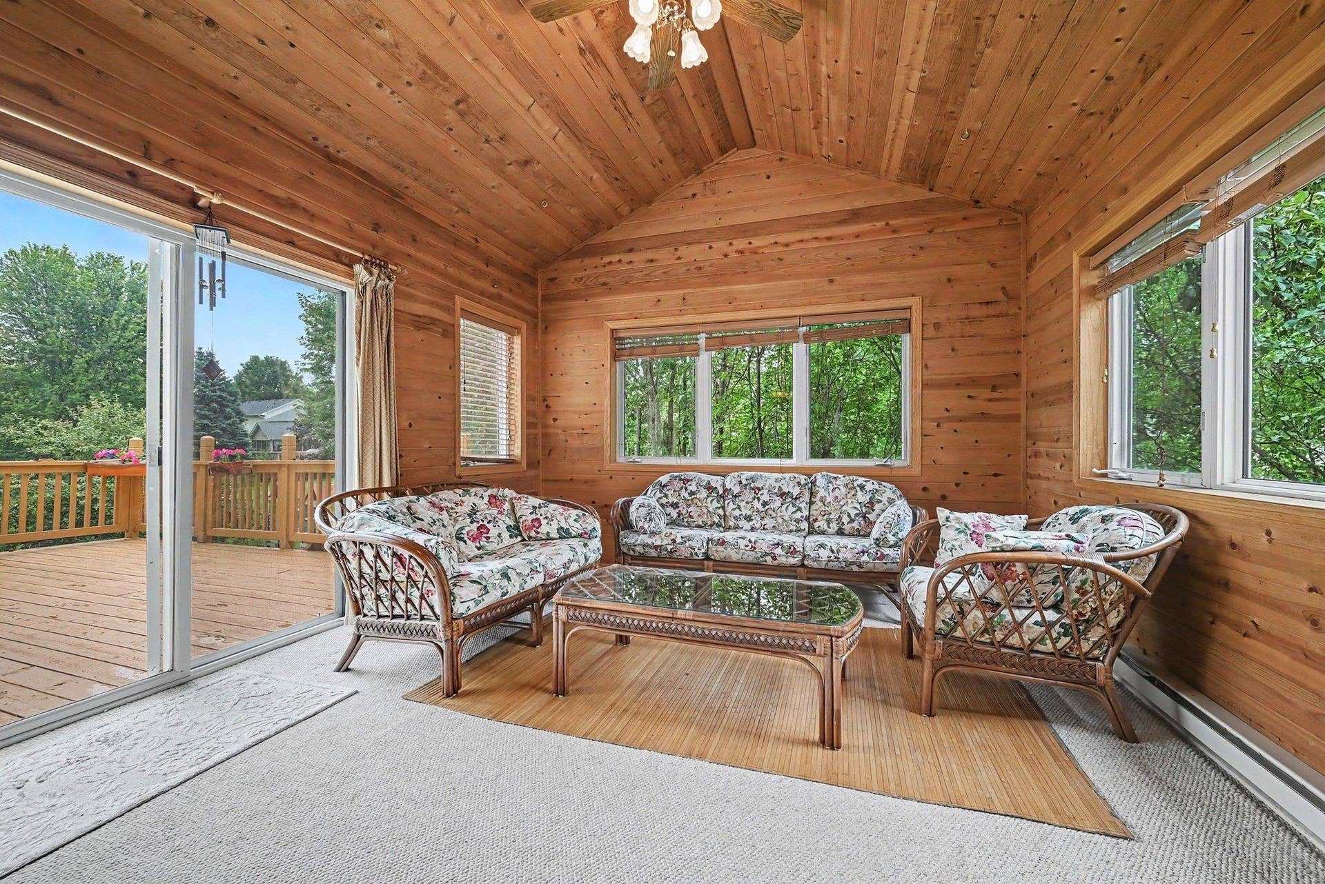 2466 Lone Eagle Trail, Woodbury, MN 55129 4 season porch off the kitchen, oversized door to the deck. Lots of natural light, mature trees provide lots of privacy.