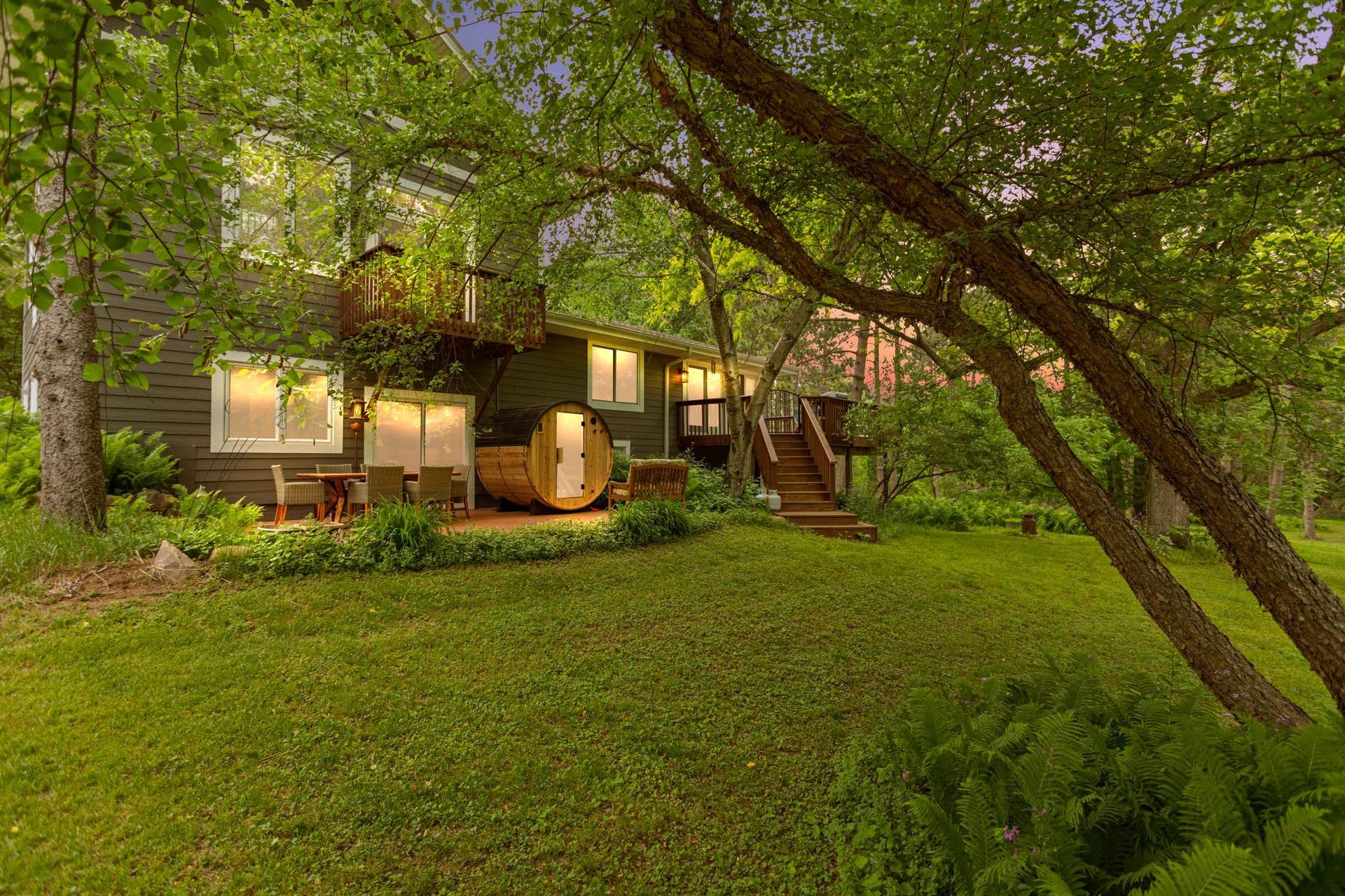 Back of house with deck, patio, sauna, and master balcony