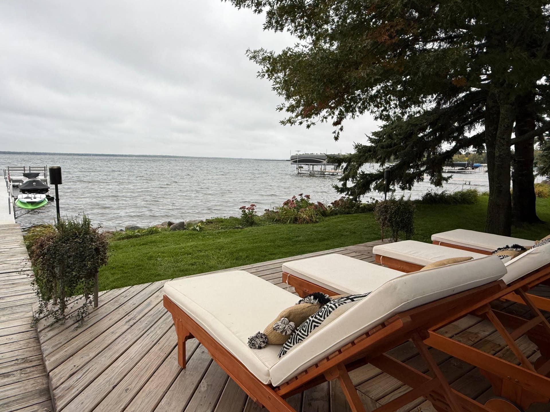 7206 Birchmont Ct. NE, Bemidji, MN 56601 exterior deck loungers water view.jpeg