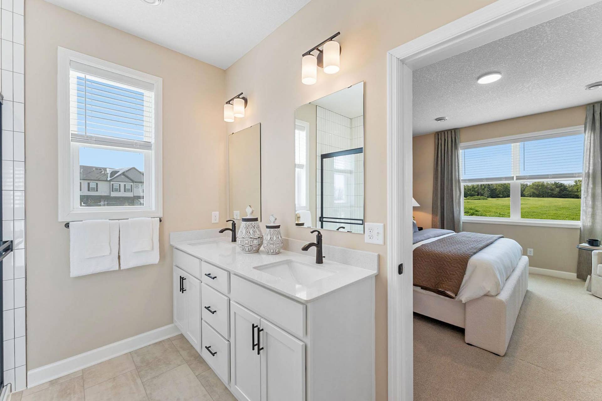 5222 Long Pointe Bay, Woodbury, MN 55129 The quartz-topped vanity showcases rectangular dual sinks, stylish cabinetry and individual glass mirrors