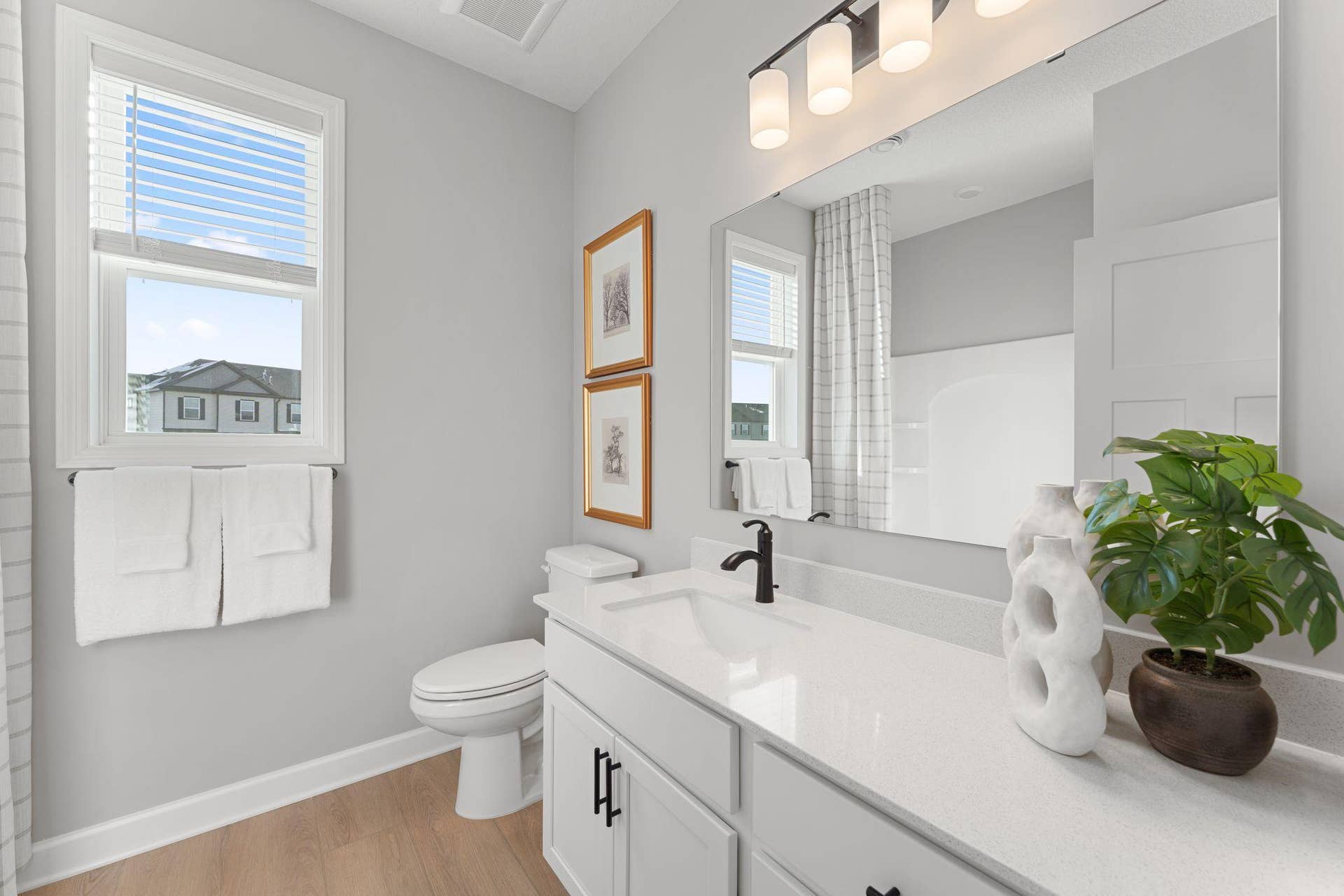 5222 Long Pointe Bay, Woodbury, MN 55129 This full-sized bathroom is arranged near the secondary bedrooms in a well-thought-out design to promote balanced living.