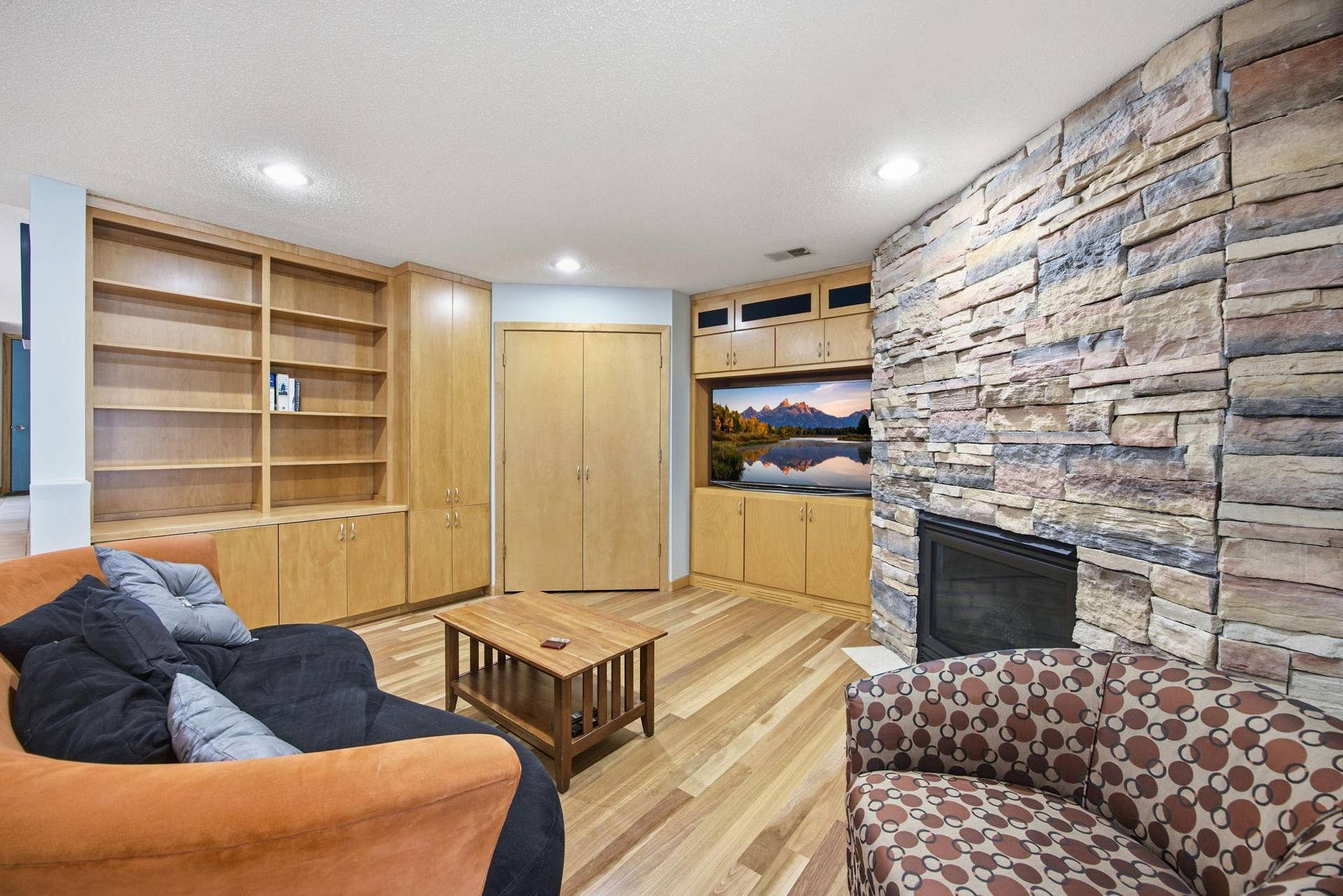 38- Custom designed with gas fireplace with stone surround and maple cabinetry built ins.
