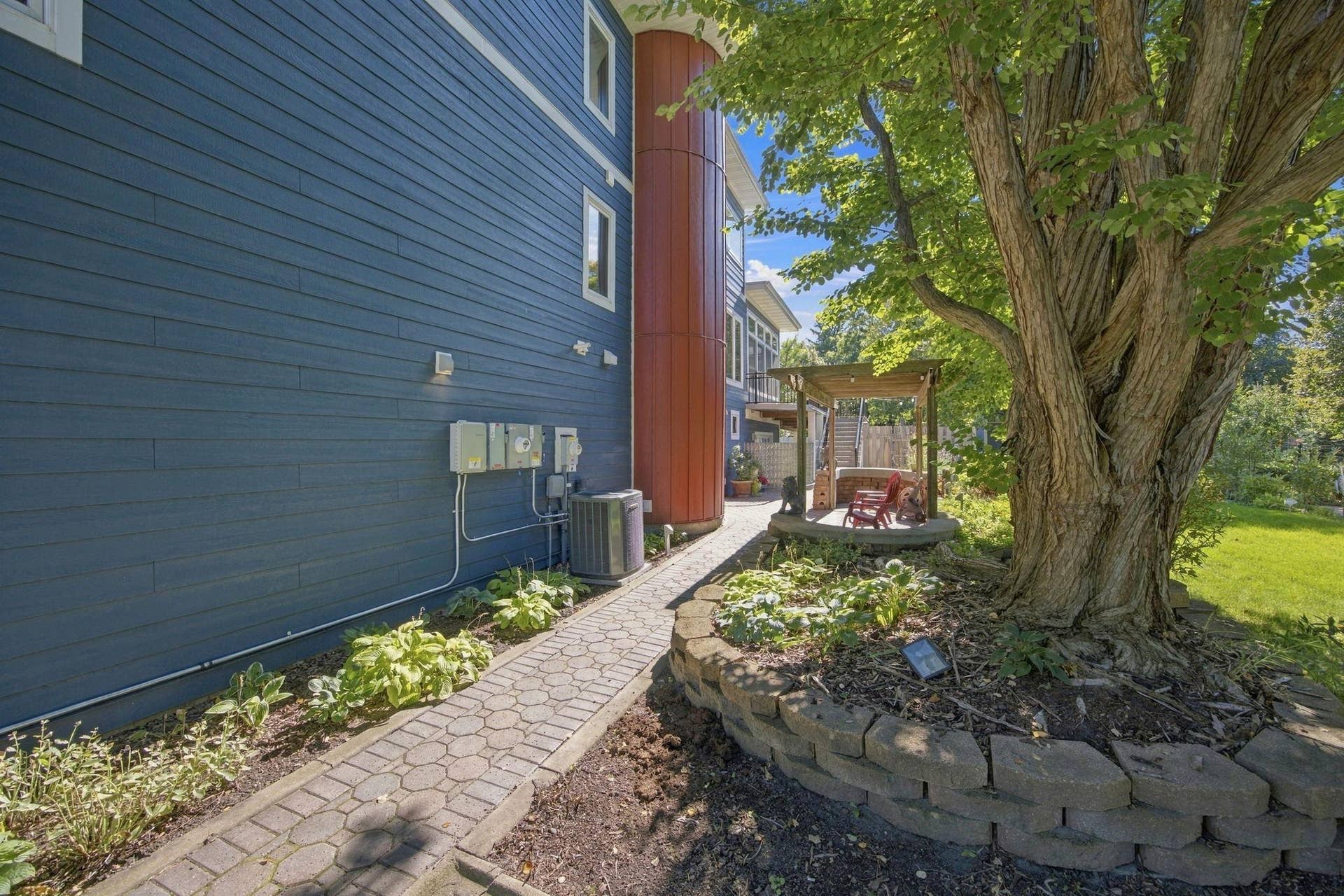 Decorative paver side walk leads to side entry.