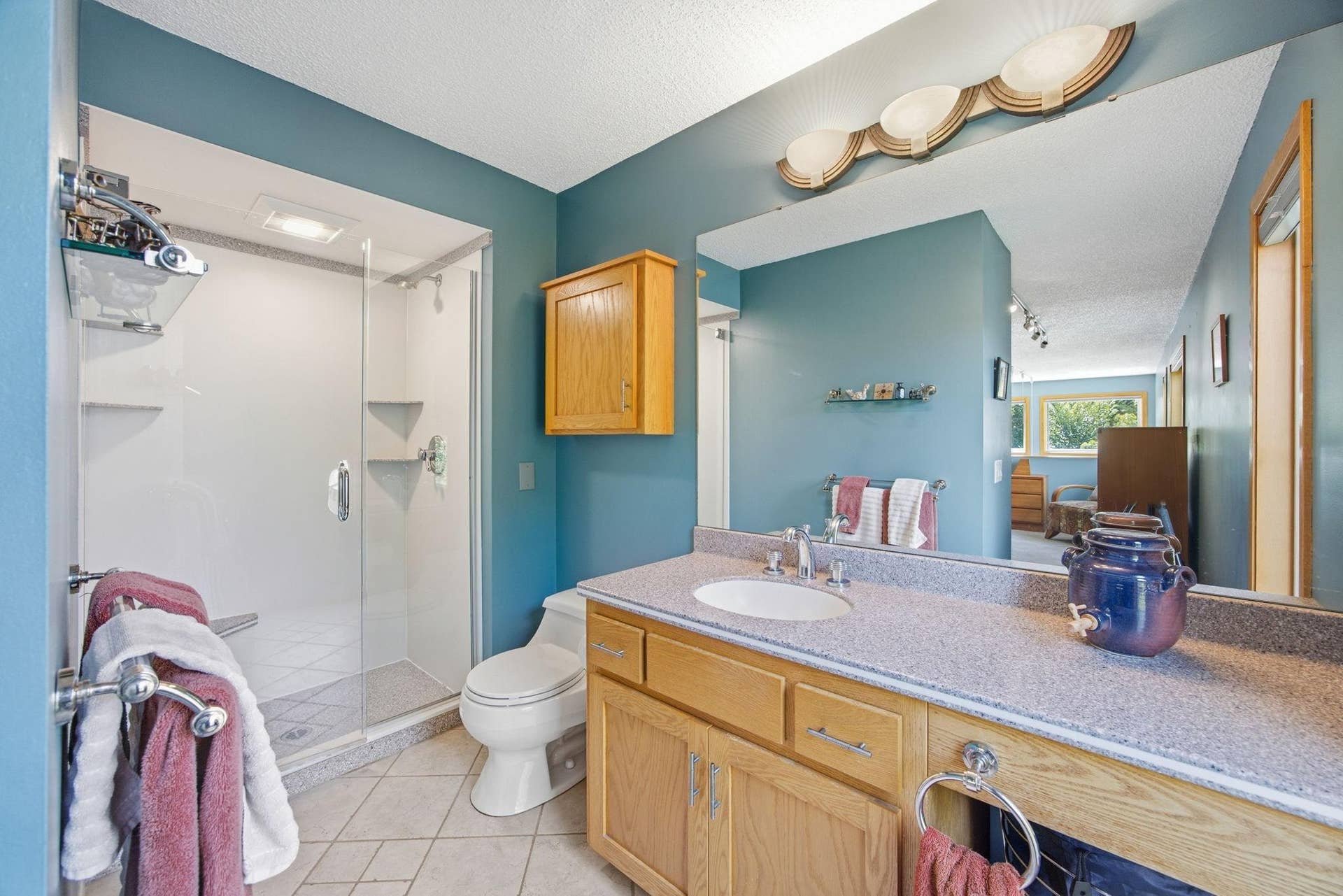 25-  3/4 bath in primary bedroom with Corian counter tops.