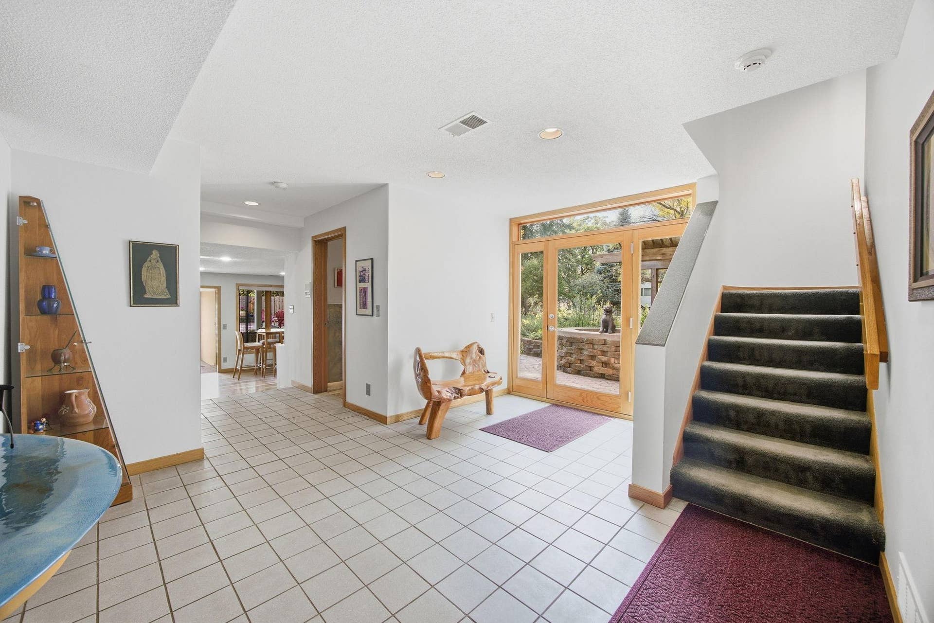 30-   Tiled entry has full glass door with glass sidelights and transom flooding entry with natural light.