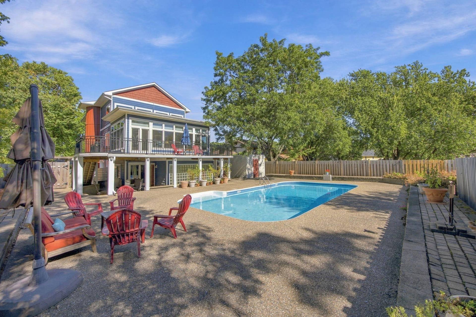 52  Rear view of home shows the seating areas both covered and closer to the pool.