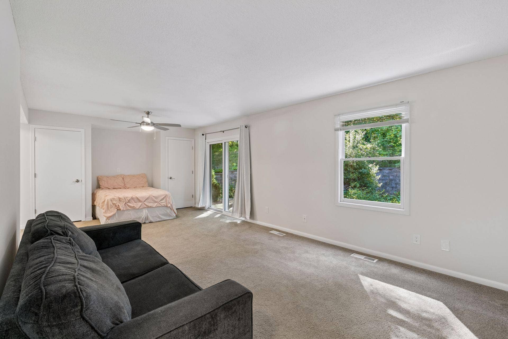 6347 Alderwood Circle, #B, Woodbury, MN 55125 living room space connects to the bedroom space - perfect crash pad and efficiency living with walkout sliding doors