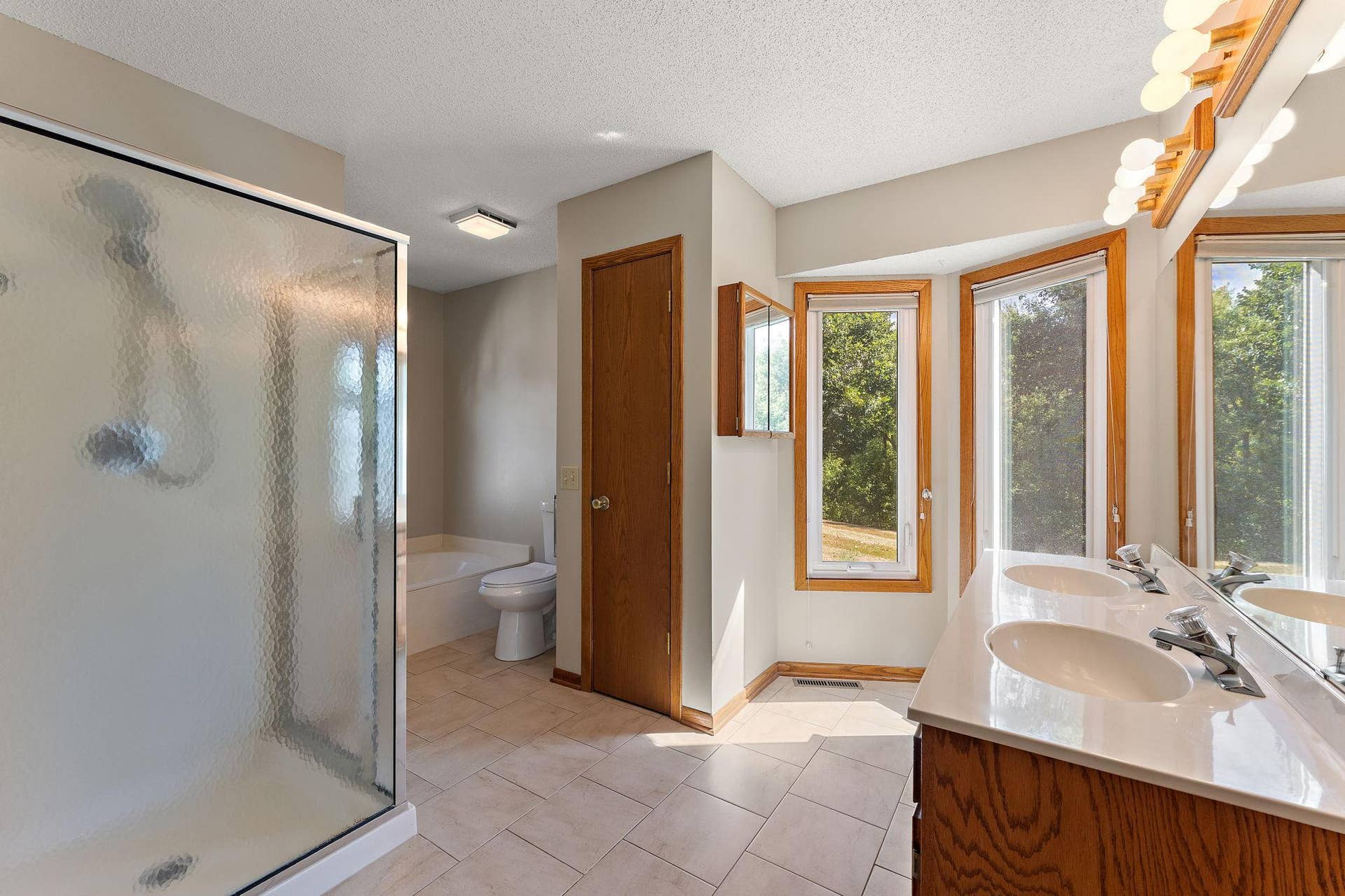 978 Winterberry Drive, Woodbury, MN 55125 Main floor bath features soaking tub and walk-in shower plus new toilet!!