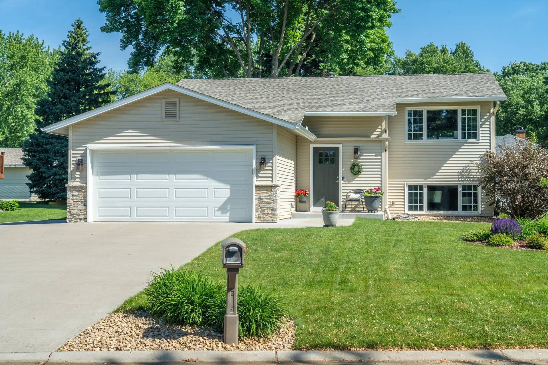14250 55th Street N, Stillwater, MN 55082 The covered front entry is framed by lush landscaping and a lawn that's clearly been loved. Welcome home.
