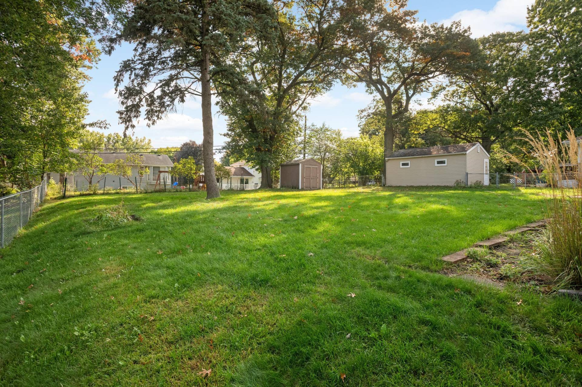 3829 Oak Street N, Brooklyn Center, MN 55429 The backyard is partially fenced and features a nice storage shed and beautiful garden area.
