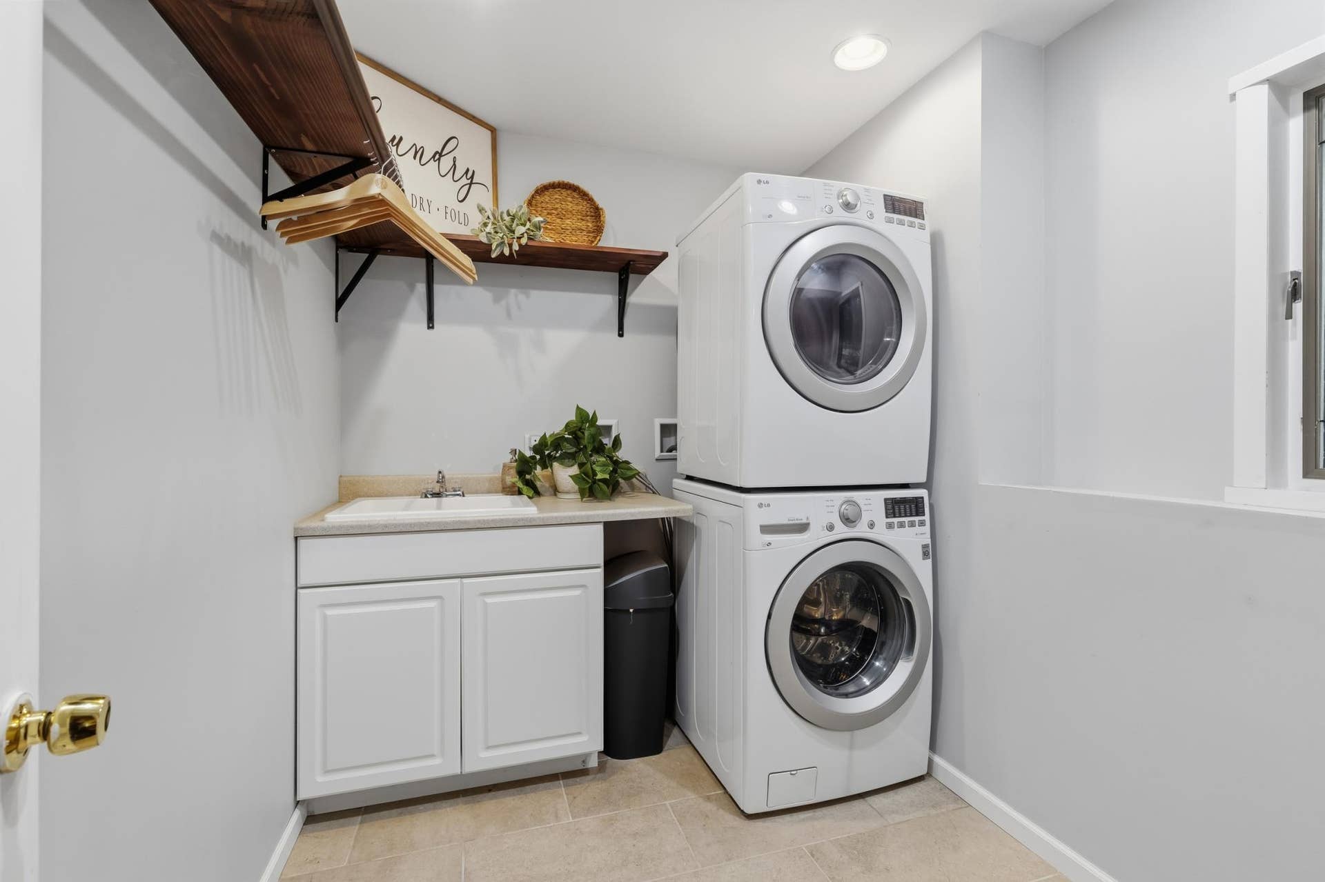 15469 Fish Point Road SE, Prior Lake, MN 55372 Laundry Room features an enameled cabinet with countertop and drop-in utility sink. Open and bright!