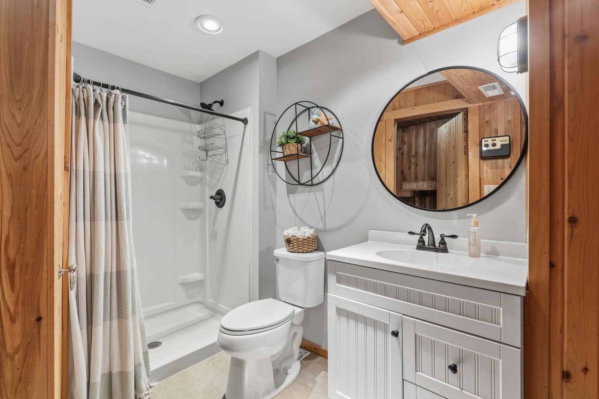 15469 Fish Point Road SE, Prior Lake, MN 55372 3/4 bathroom features partial wood paneled walls and ceiling, enameled vanity cabinet and ceramic tile flooring