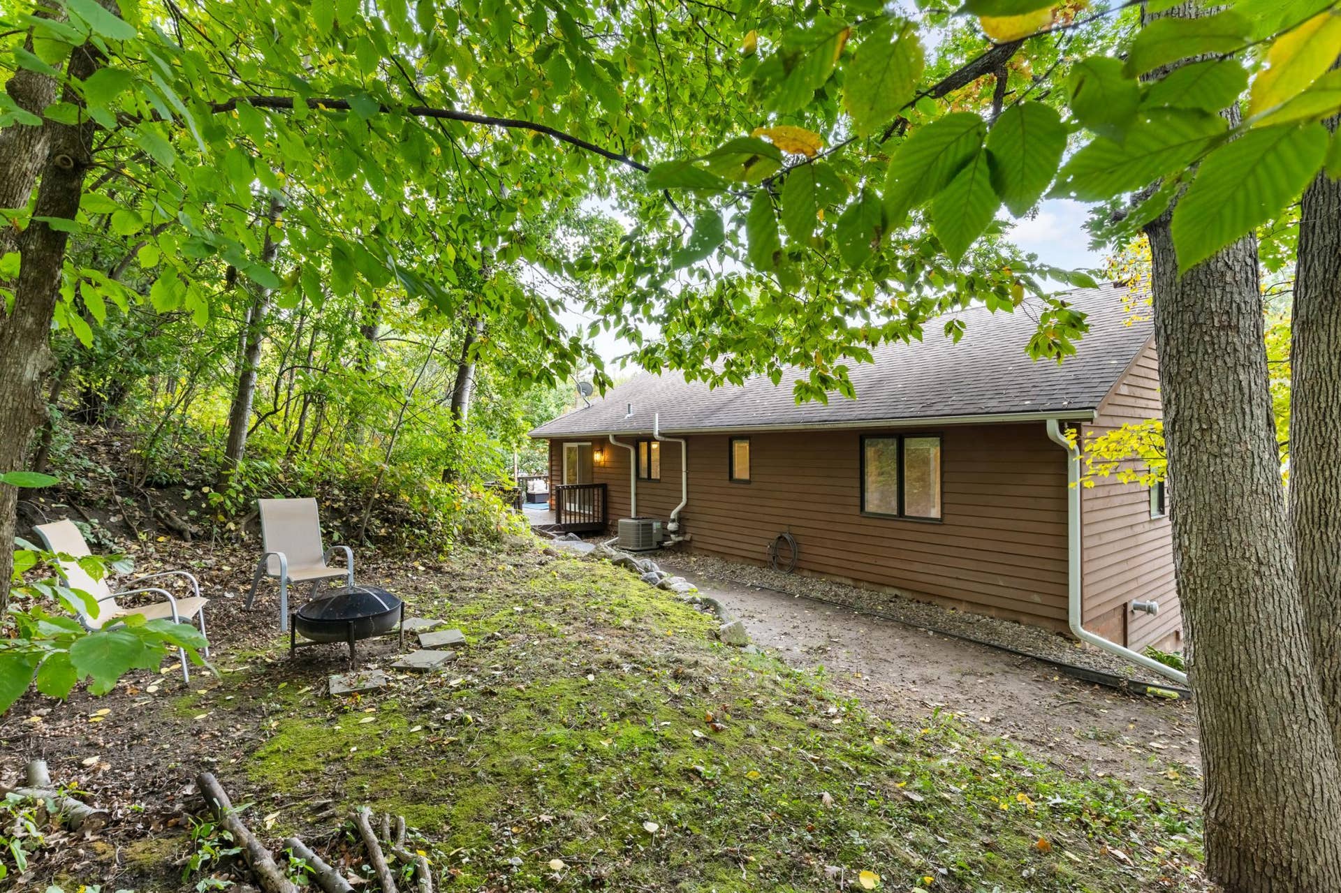 15469 Fish Point Road SE, Prior Lake, MN 55372 Mature landscape includes boulder retaining walls, majestic trees, mulched gardens and open area with fire pit!