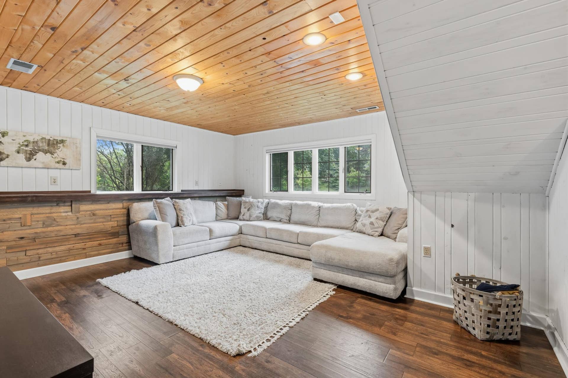 15469 Fish Point Road SE, Prior Lake, MN 55372 The Lower Level Family Room features wood paneled walls and ceilings, laminate flooring and offers a garage entry in a separate area